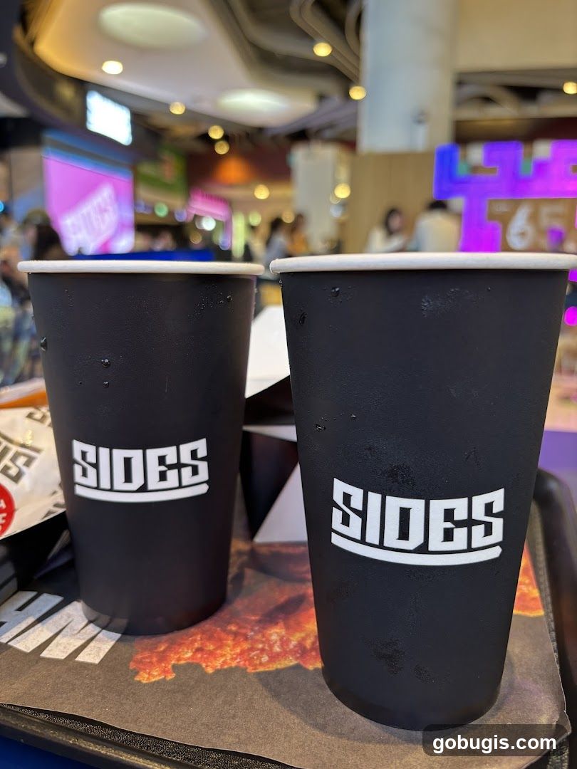 Two black cups with the logo "SIDES"