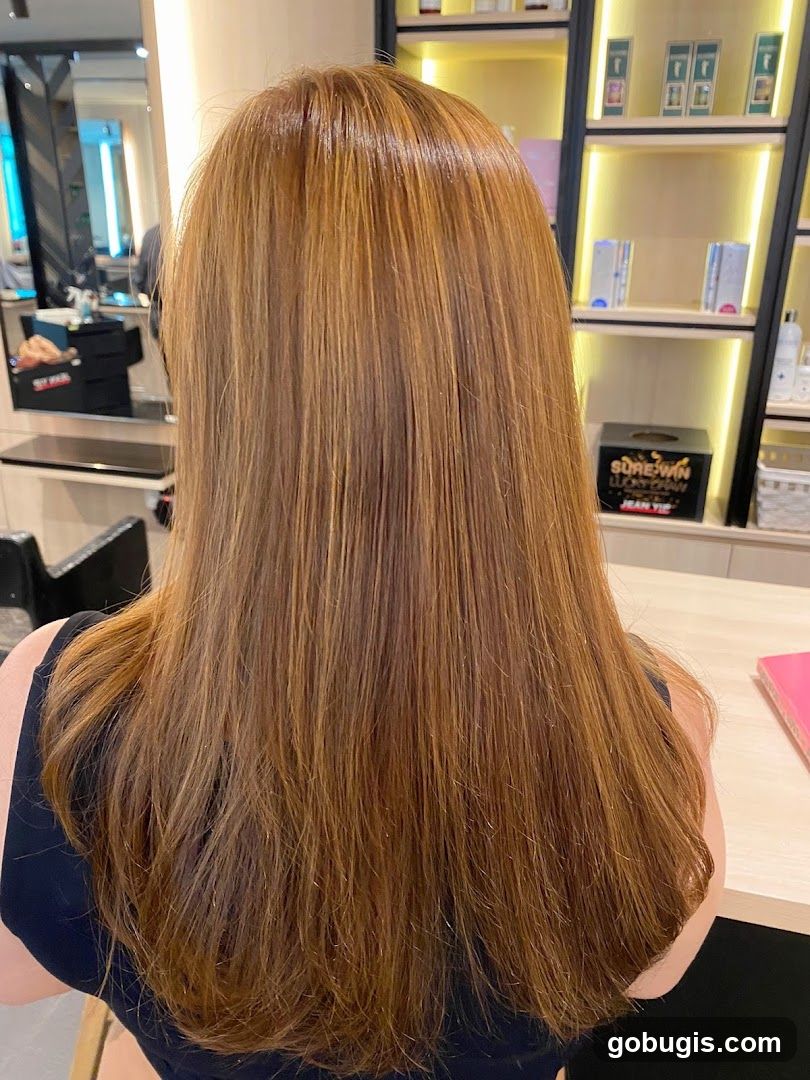 Woman with long, layered, auburn hair