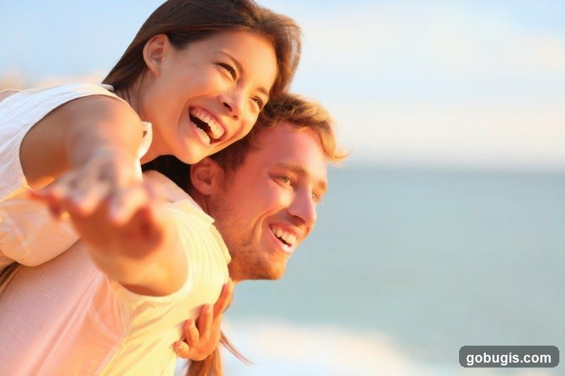 Couple enjoying a piggyback ride on the beach