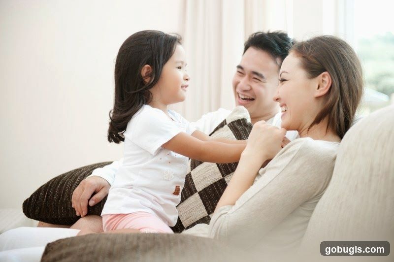 Family laughing on a couch
