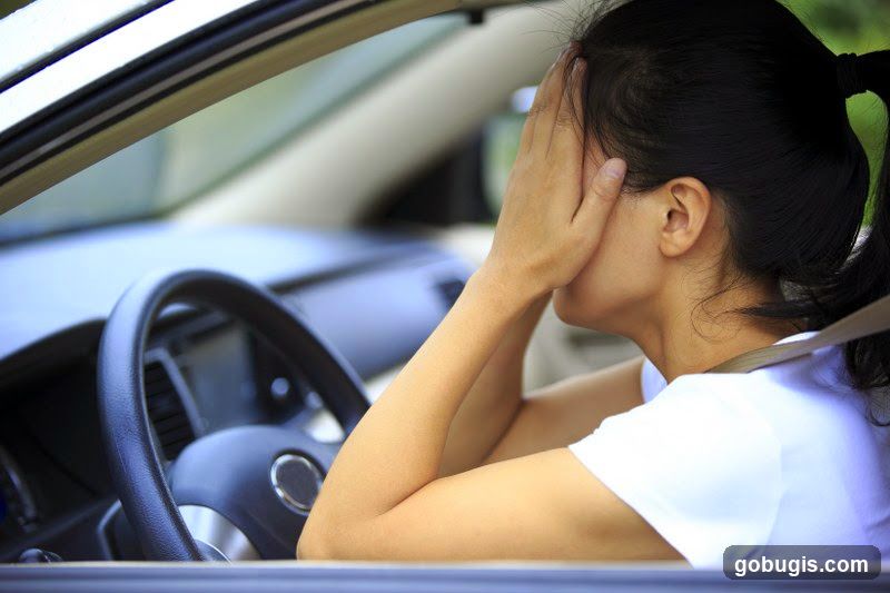 Woman covering face in car