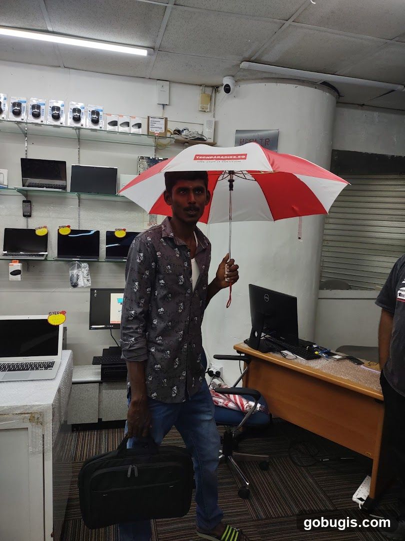 Man holding an umbrella indoors