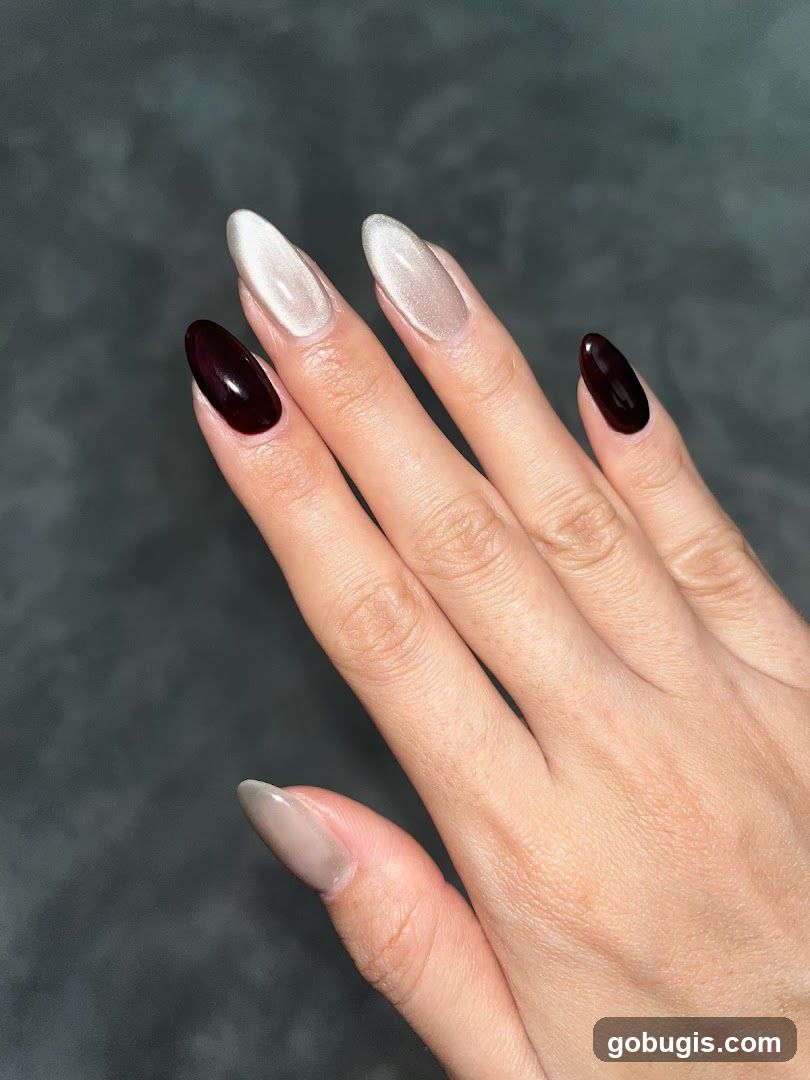 Almond-shaped nails with cat-eye and dark red polish