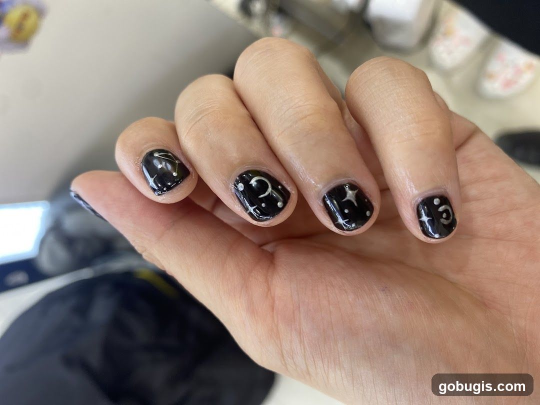 Black Nails with Celestial Designs