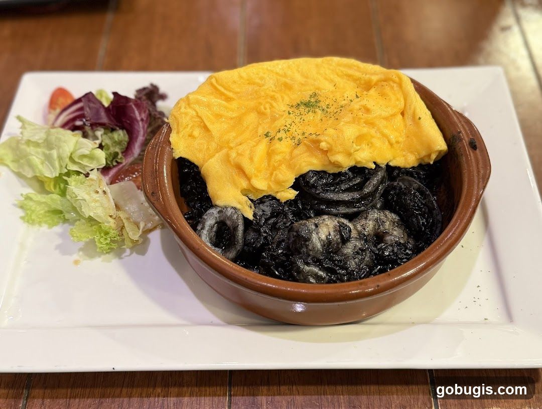 Squid Ink Rice with Omelette and Salad