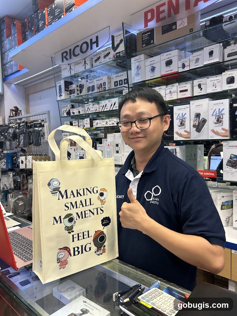Man holding a tote bag in a camera store