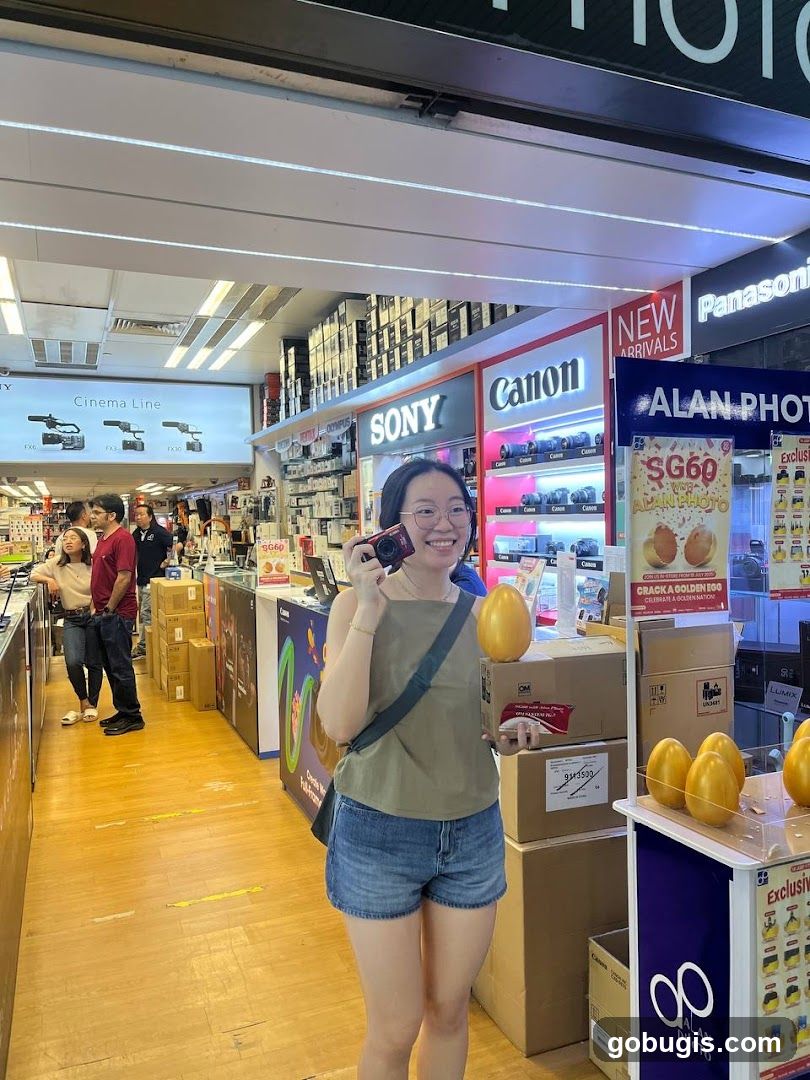 Woman holding a camera and golden eggs in a camera store