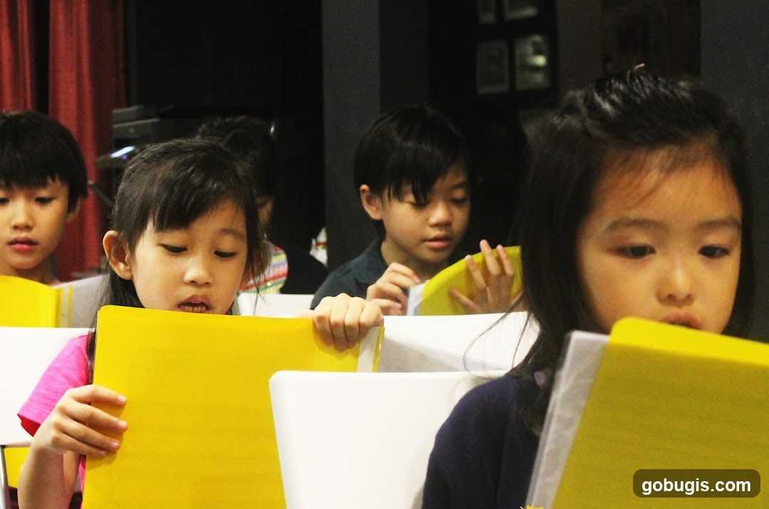 Children reading yellow books