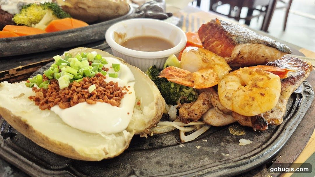 Sizzling Platter with Baked Potato, Salmon, and Shrimp