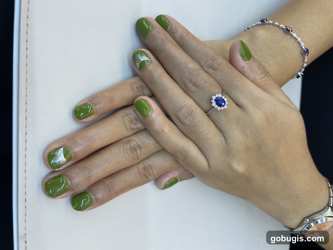 Hands with green nail polish and jewelry