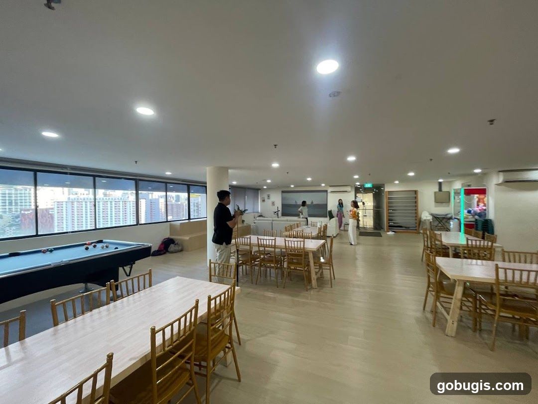 Indoor common area with pool table and dining tables