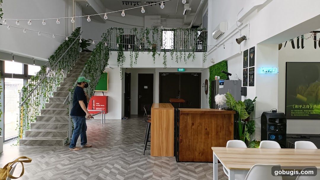 Interior of a cafe with a staircase and seating area