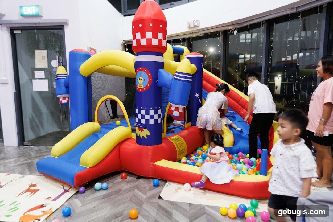 Children Playing in a Rocket-Themed Inflatable