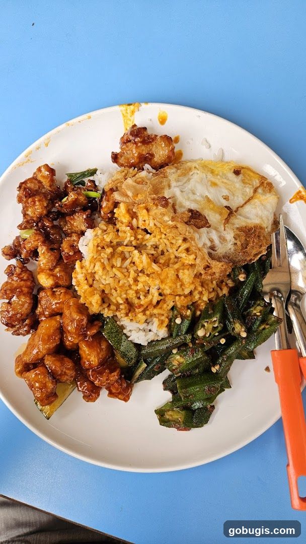 Plate of food with fried chicken, rice, and okra