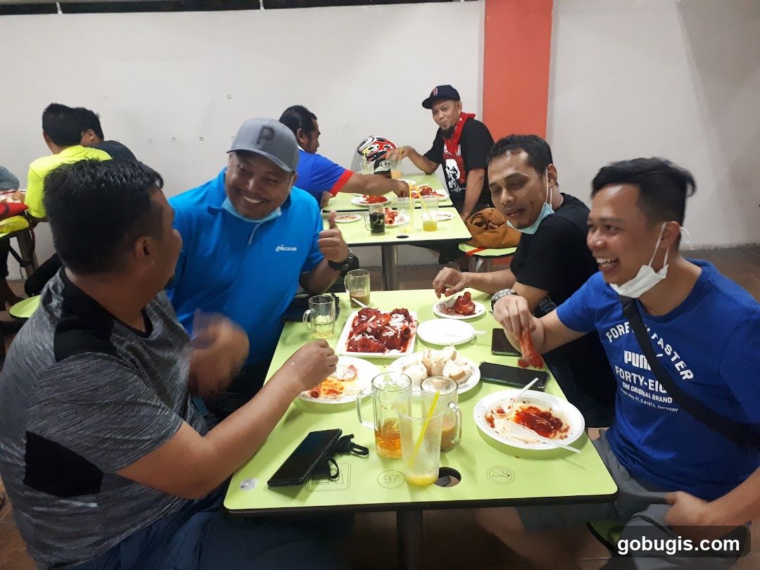 Group of men eating at tables