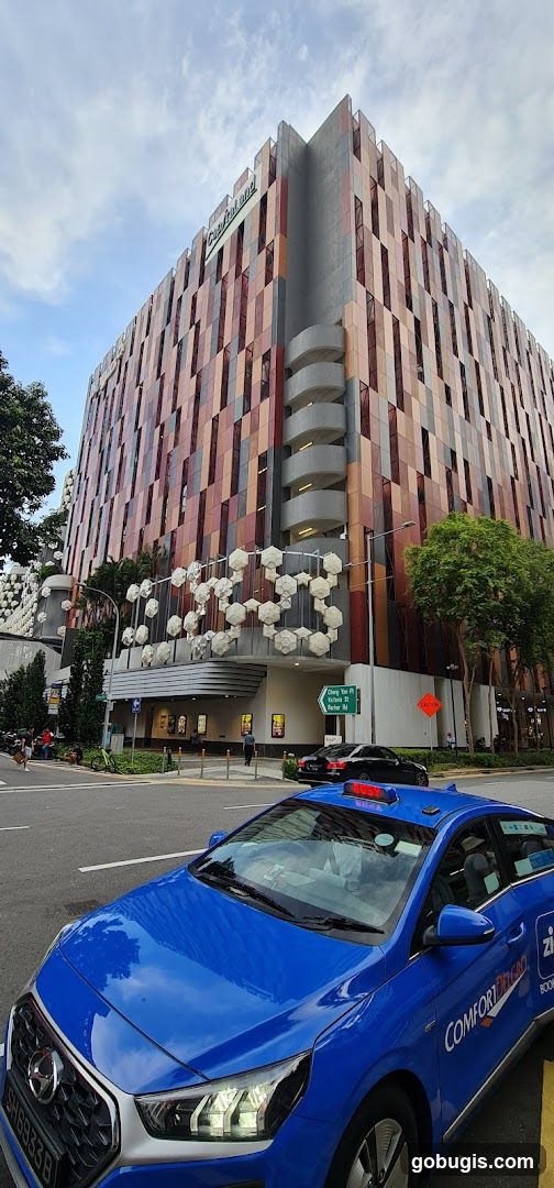 Modern Building Facade with Blue Taxi