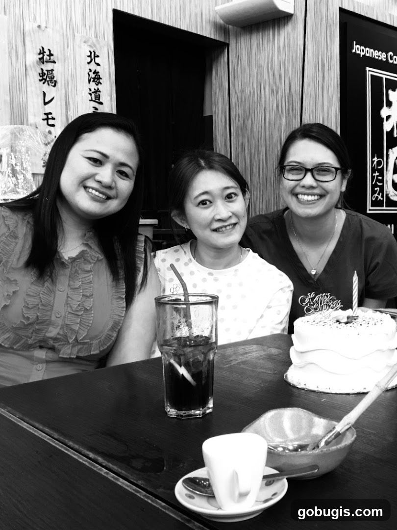 Three women celebrating with a cake