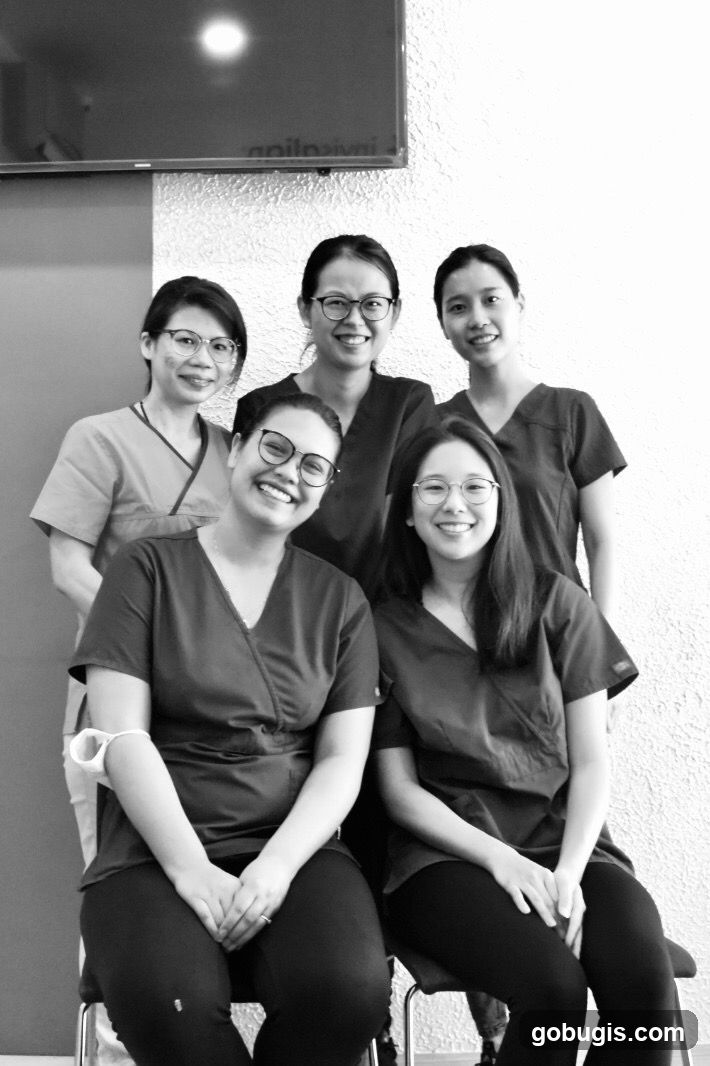 Five women in scrubs smiling