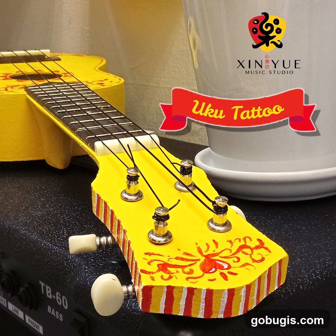 Yellow Ukulele with "Uku Tattoo" Banner