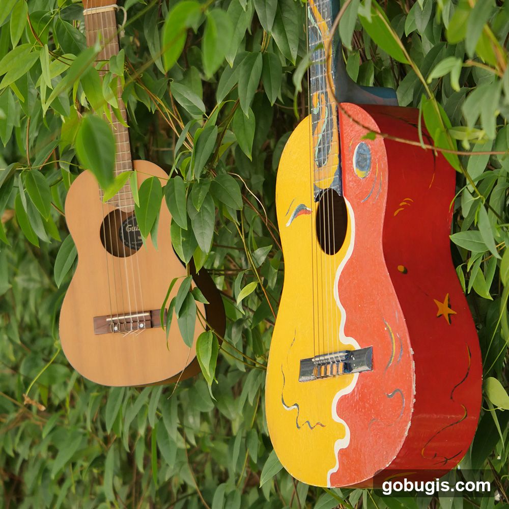 Guitars Hanging in Foliage