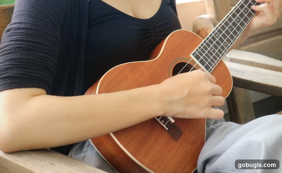 Person Playing Ukulele