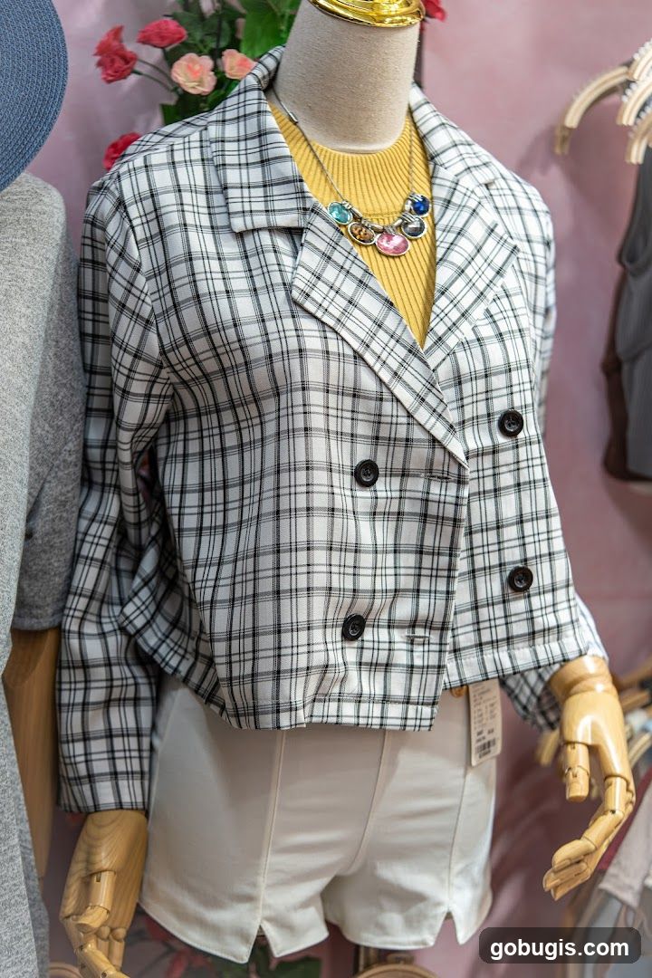 Mannequin wearing a plaid jacket and white shorts
