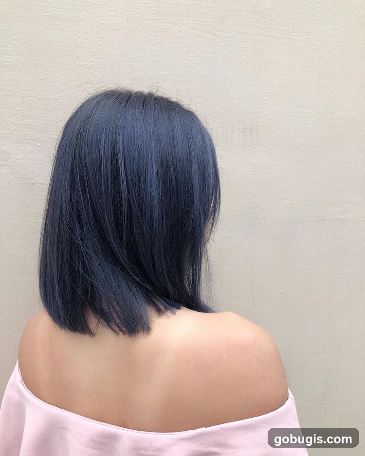 Woman with dark blue bob haircut