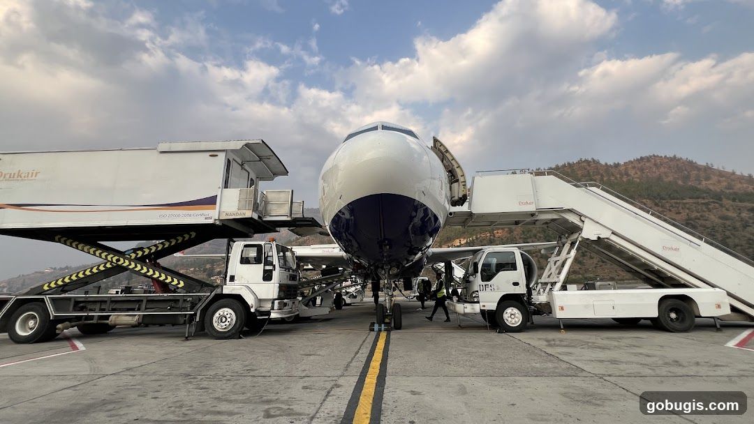 Airplane at Airport with Service Vehicles