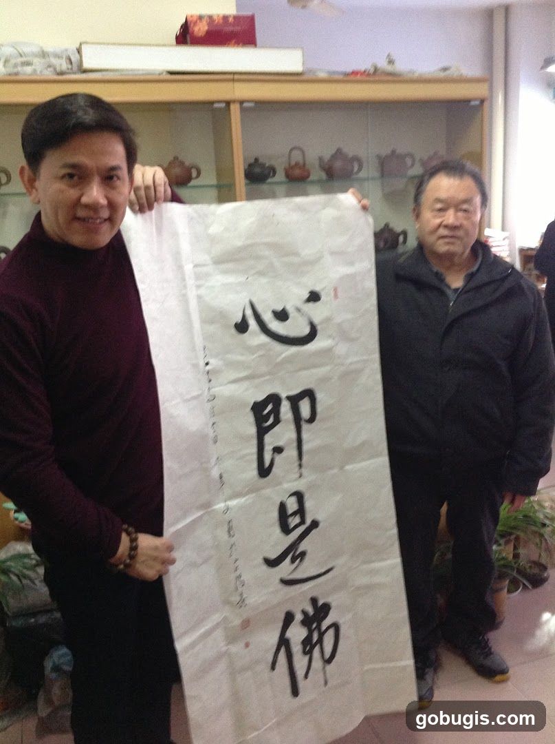 Two men holding a scroll with calligraphy