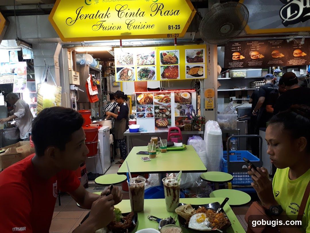 People eating at a food stall