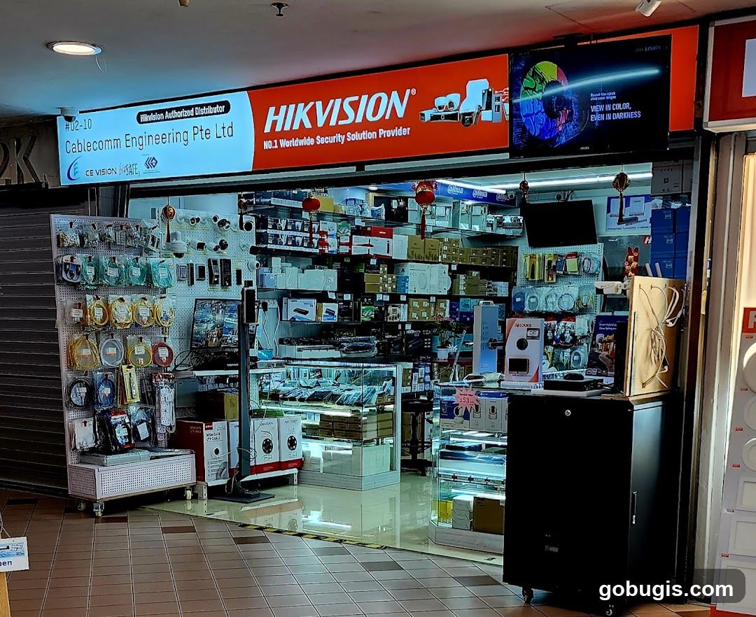The storefront of Cablecomm Engineering Pte Ltd, an authorized distributor of Hikvision security solutions. The shop displays various security equipment and accessories.