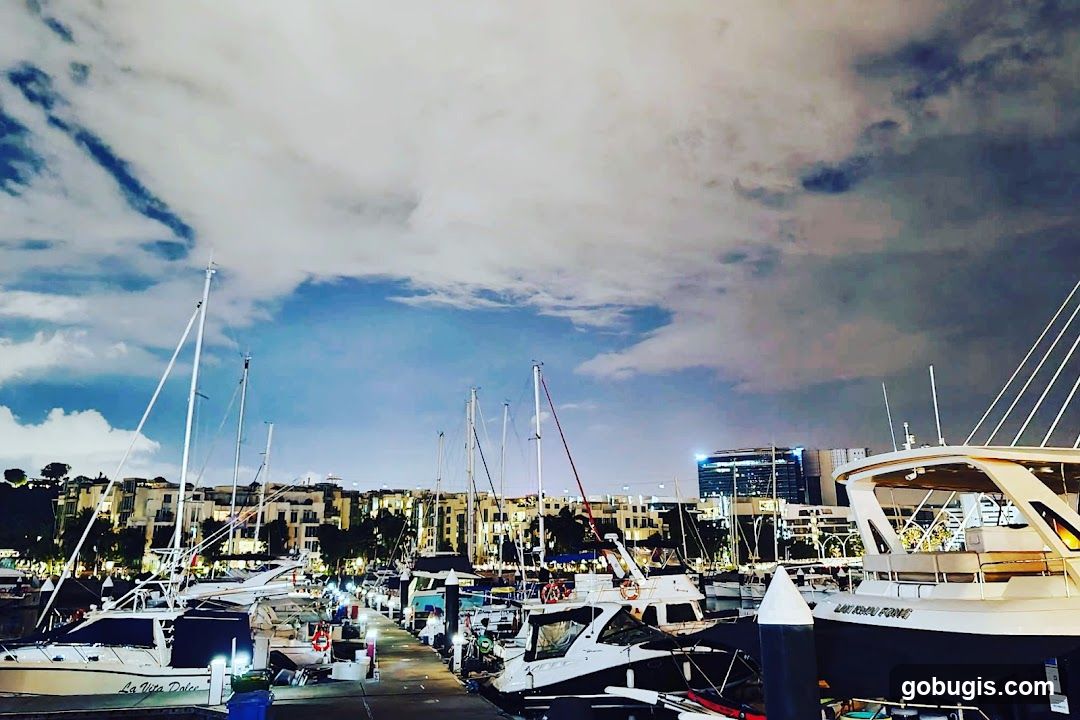 Boats docked at a marina at dusk