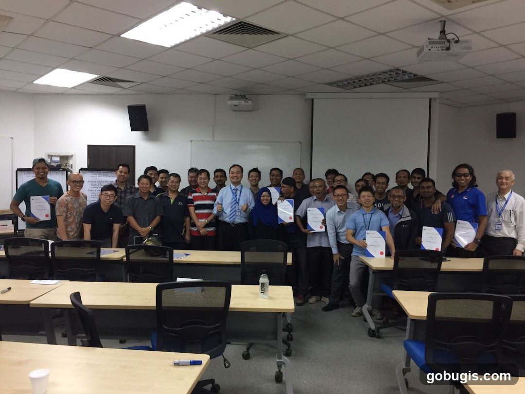 Group of people holding certificates in a classroom